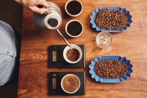 Home barista measuring coffee and water ratio